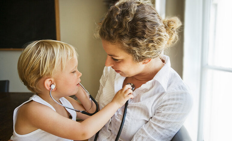 A child listen to their mother's heartbeat with a stethoscope