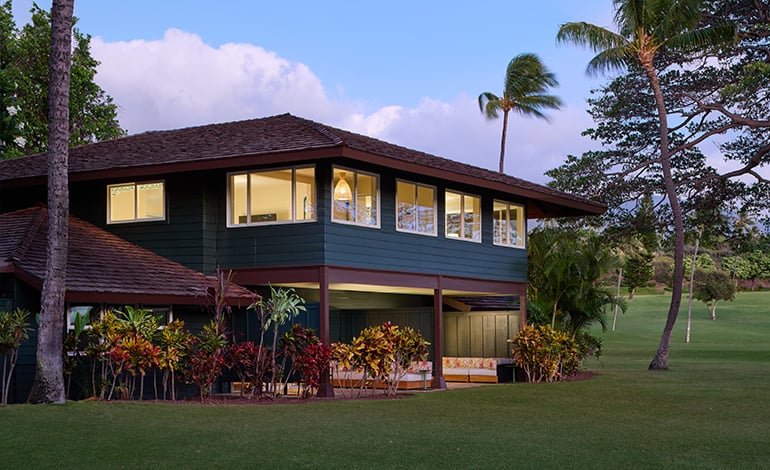 Double bed with a view of a sofa and dining table adjacent