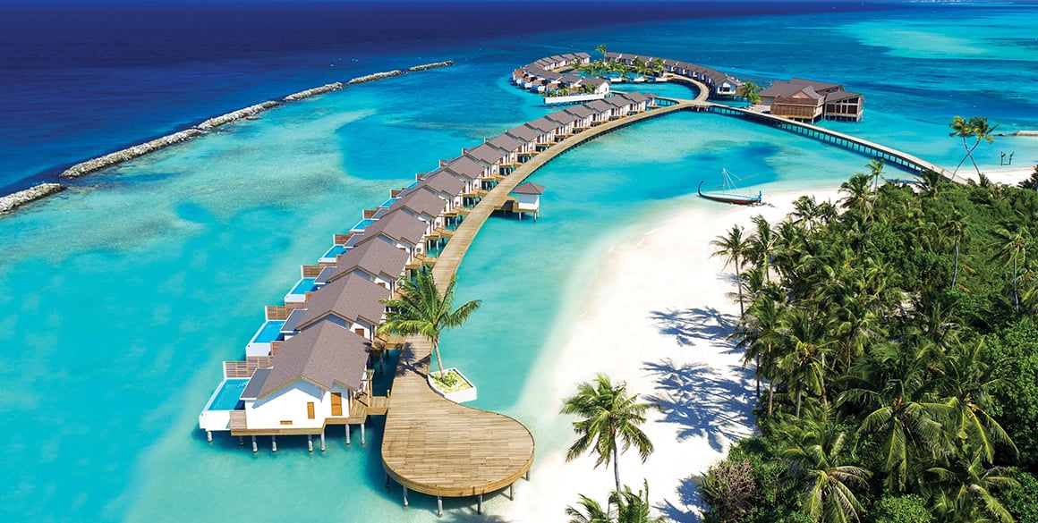 Aerial view of a chain of overwater bungalows in the Maldives