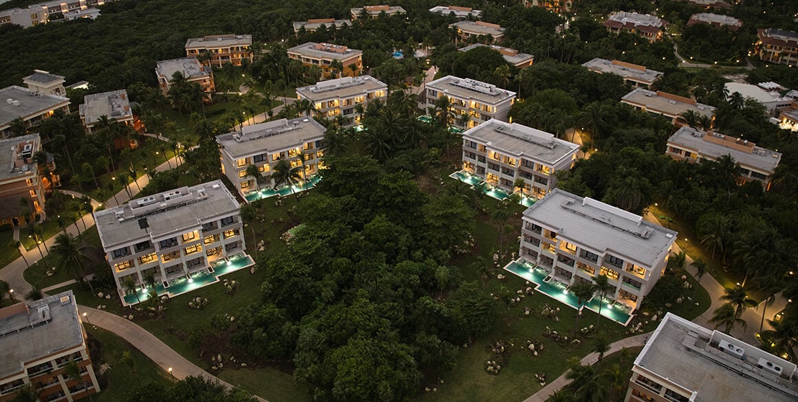 Overview of resort buildings in a V formation at sunset