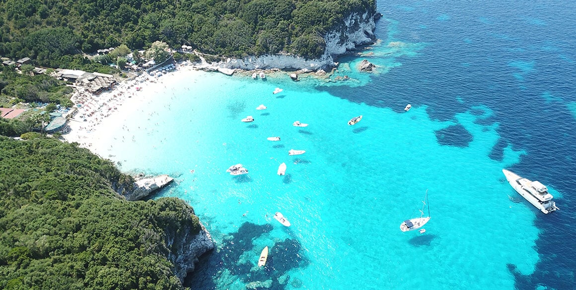 Aerial view of a Caribbean island bay with boats floating in the sea