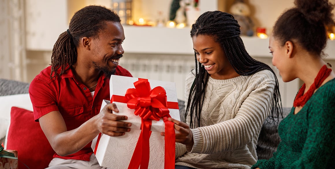 Young family unwrapping a present
