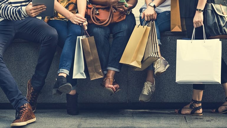 Group of people sitting with shopping bags