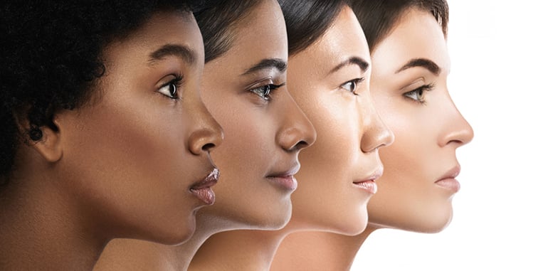 Four women of multiple ethnicities showing range of skin color