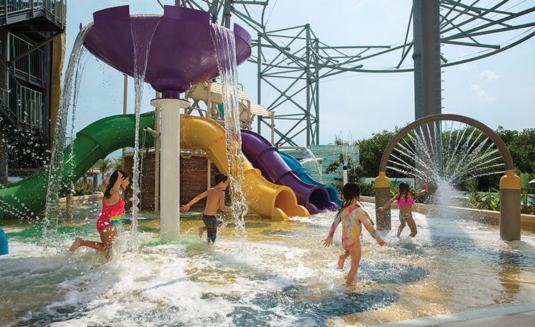 Kids playing at the children's splash park at Dreams Natura Resort & Spa in Riviera Cancun, Mexico