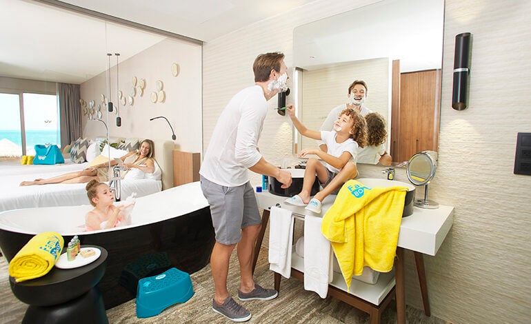 A family of four playing around in the bathroom of a Family Selection suite at Grand Palladium Costa Mujeres Resort & Spa outside of Cancun, Mexico