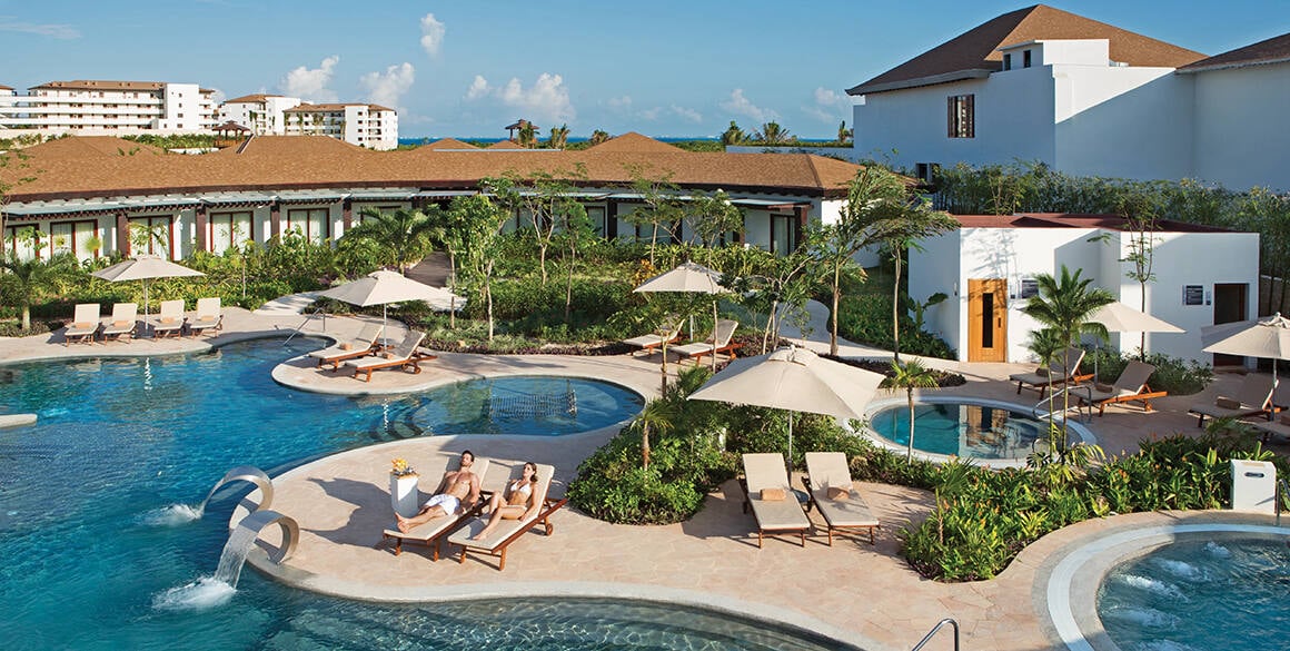 A couple laying on lounge chairs at an outdoor hydrotherapy facility