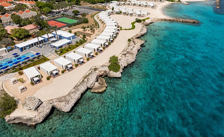 Aerial view of a coastal resort Dreams Curacao's beachfront bungalows