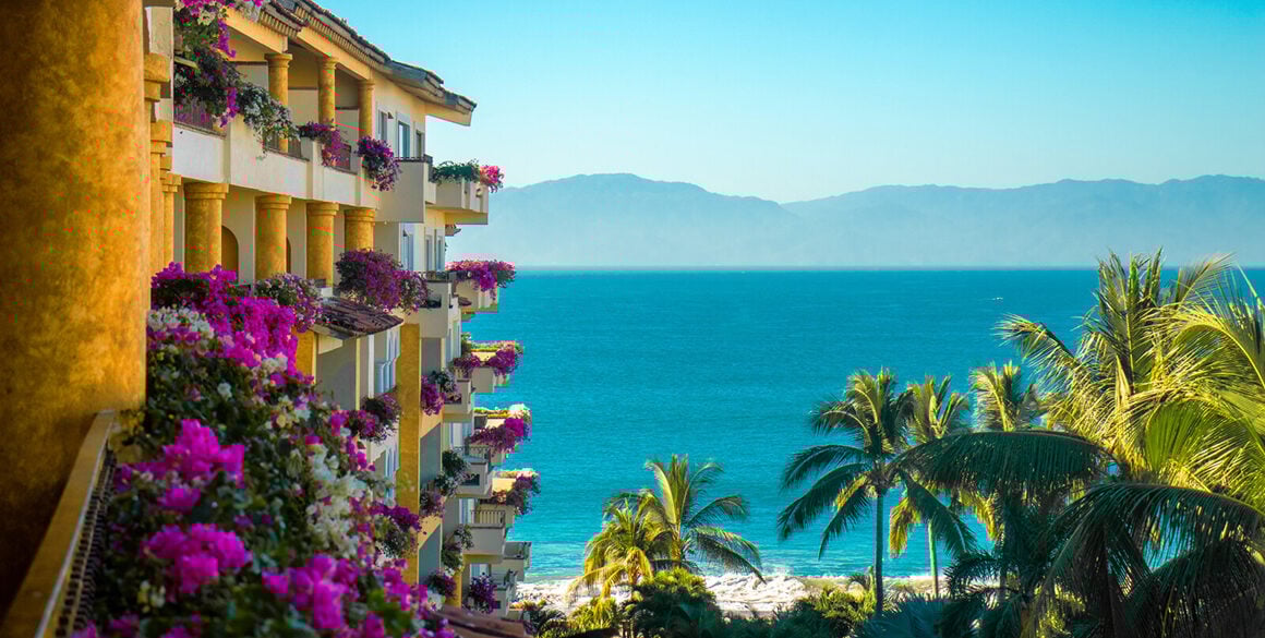 Balconies overlooking water and mountain silhouette