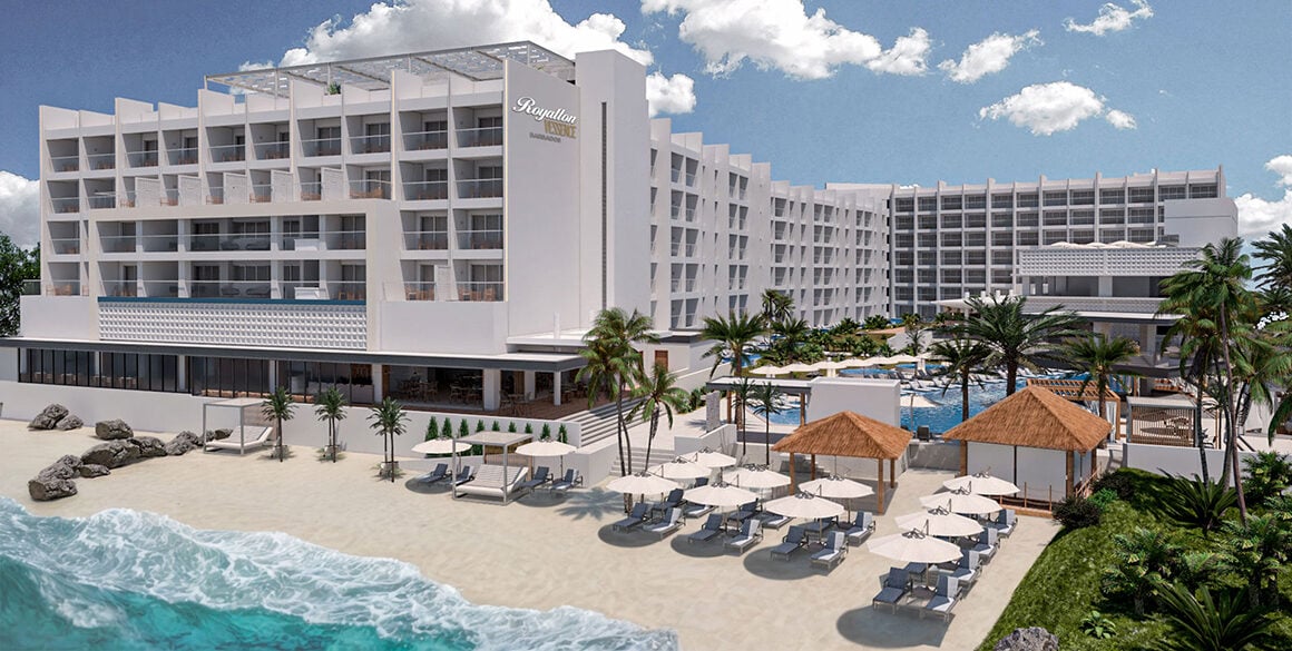 Rendering of a white mid-rise resort building on a short beach with waves lapping up