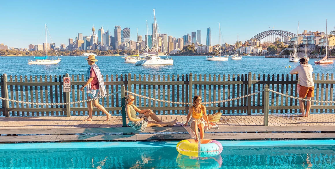 People hanging out at rooftop pool overlooking Sydney Harbour