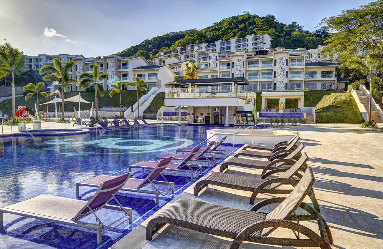 View of the buildings from the pool and lounge chairs