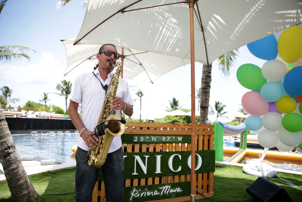 Man playing the saxophone by the pool