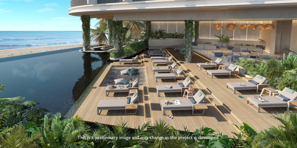 An oceanfront rooftop pool deck with three rows of lounge chairs.