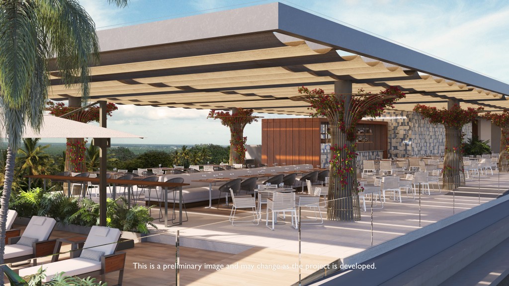 Outdoor seating area overlooking tropical foliage during the daytime.