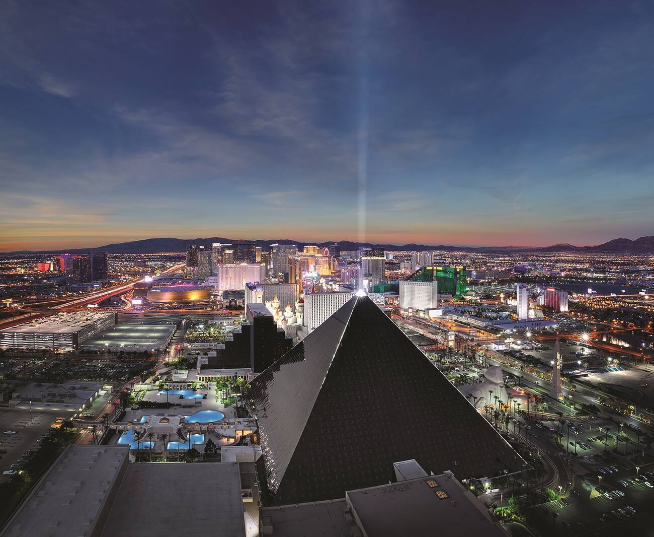 Arial view of city and pyramid with light beam at the Luxor 