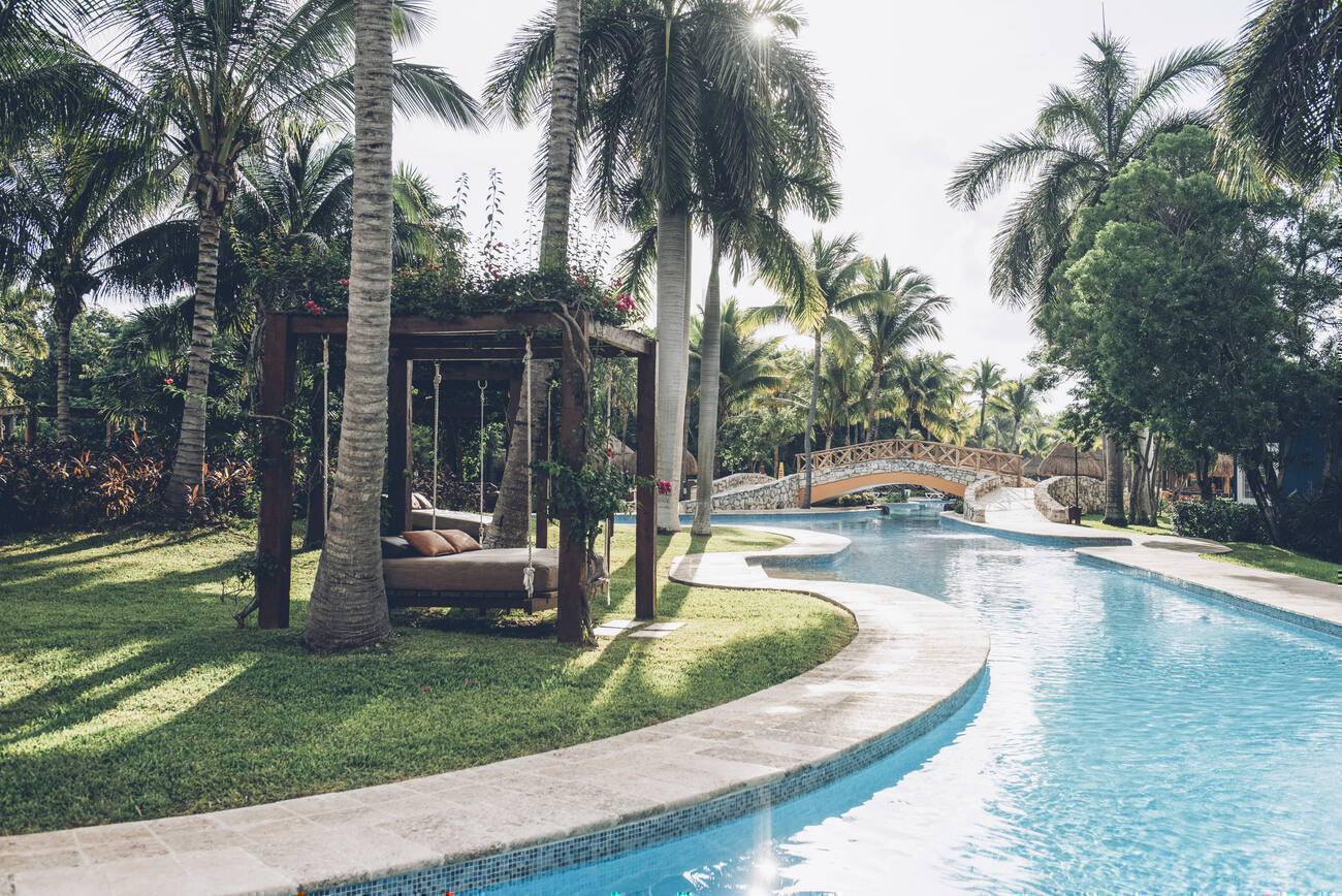 Hanging daybeds by a lazy river