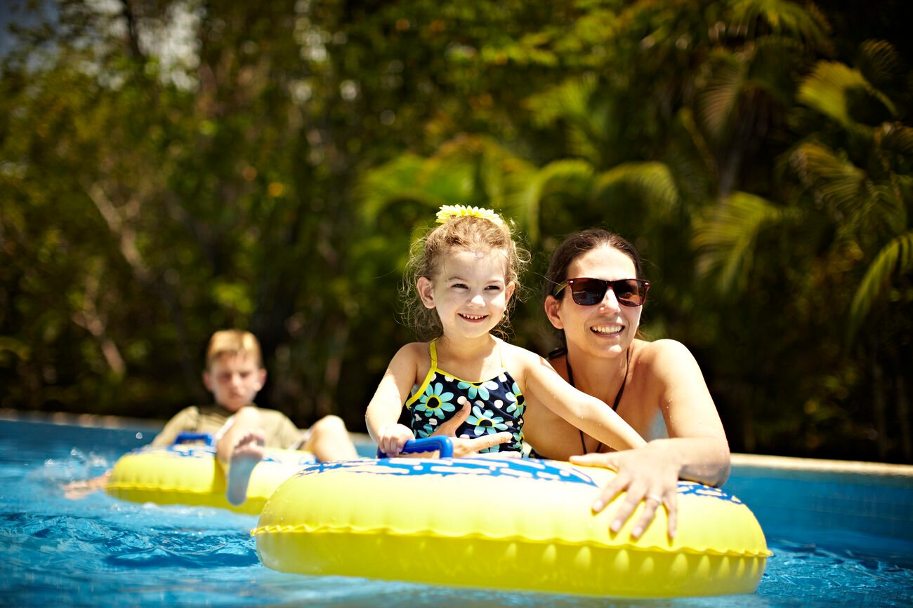 Woman and children on floats in the water