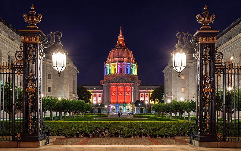 Building lit up with pride colors