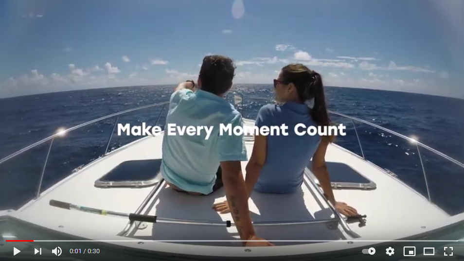 Couple sitting in the front of a deluxe double-decker deep sea fishing boat