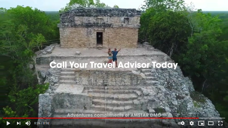 Couple posing on top of the tallest pyramid at Coba