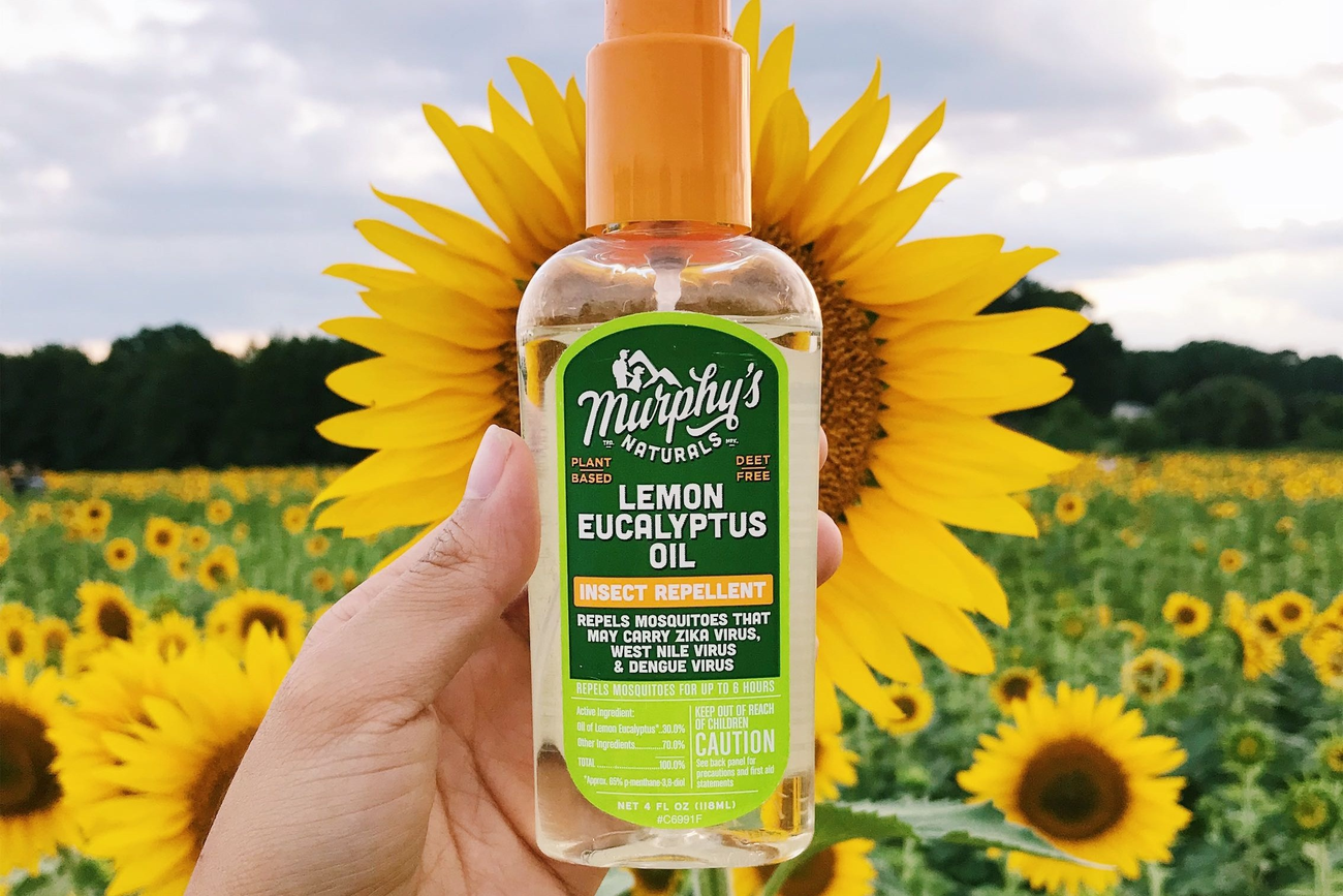 Bottle of lemon eucalyptus insect repellent in a sunflower field