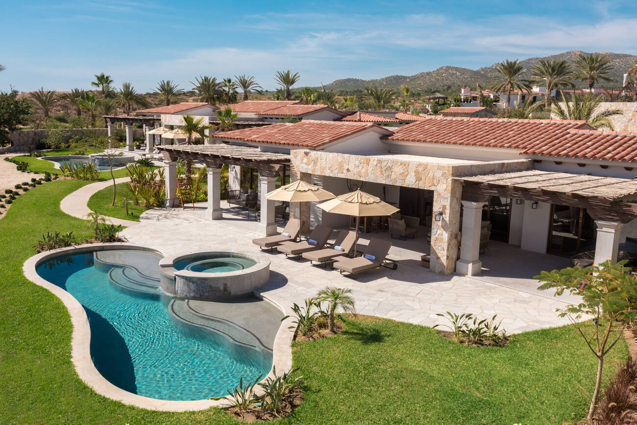 An exterior view of a Four Bedroom Premier Residence's sundeck with private pool.