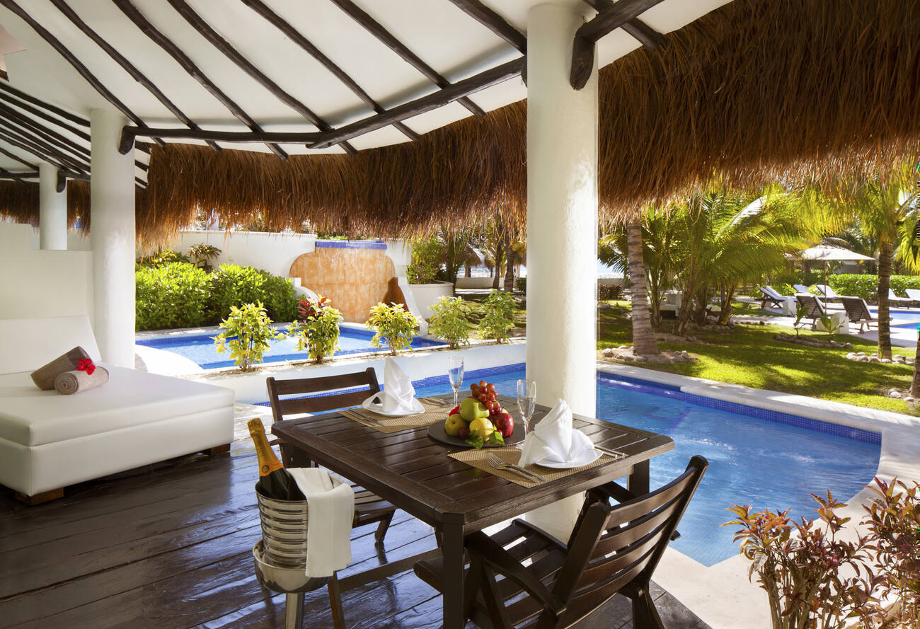 Poolside table and lounge chaise with chilled champagne