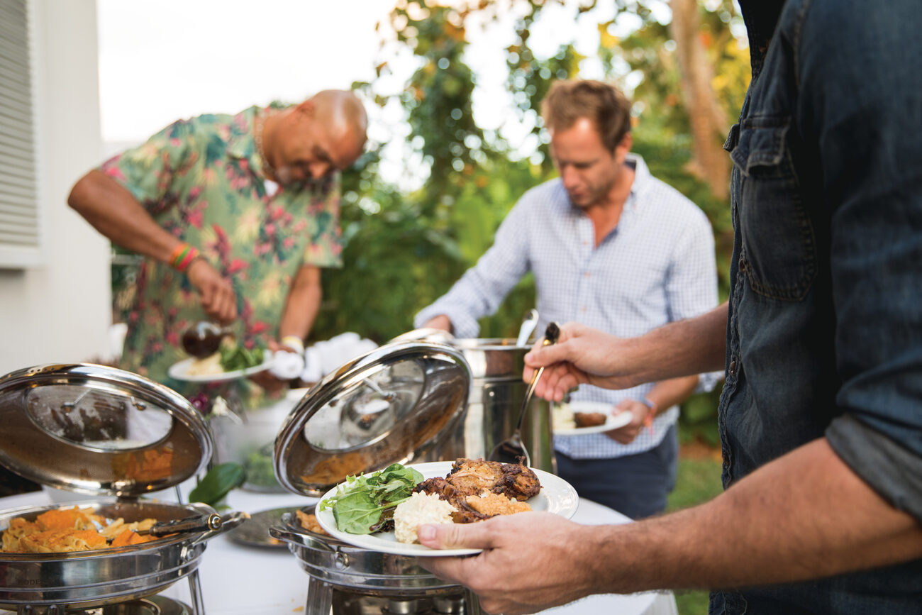 People serving themselves food buffet style