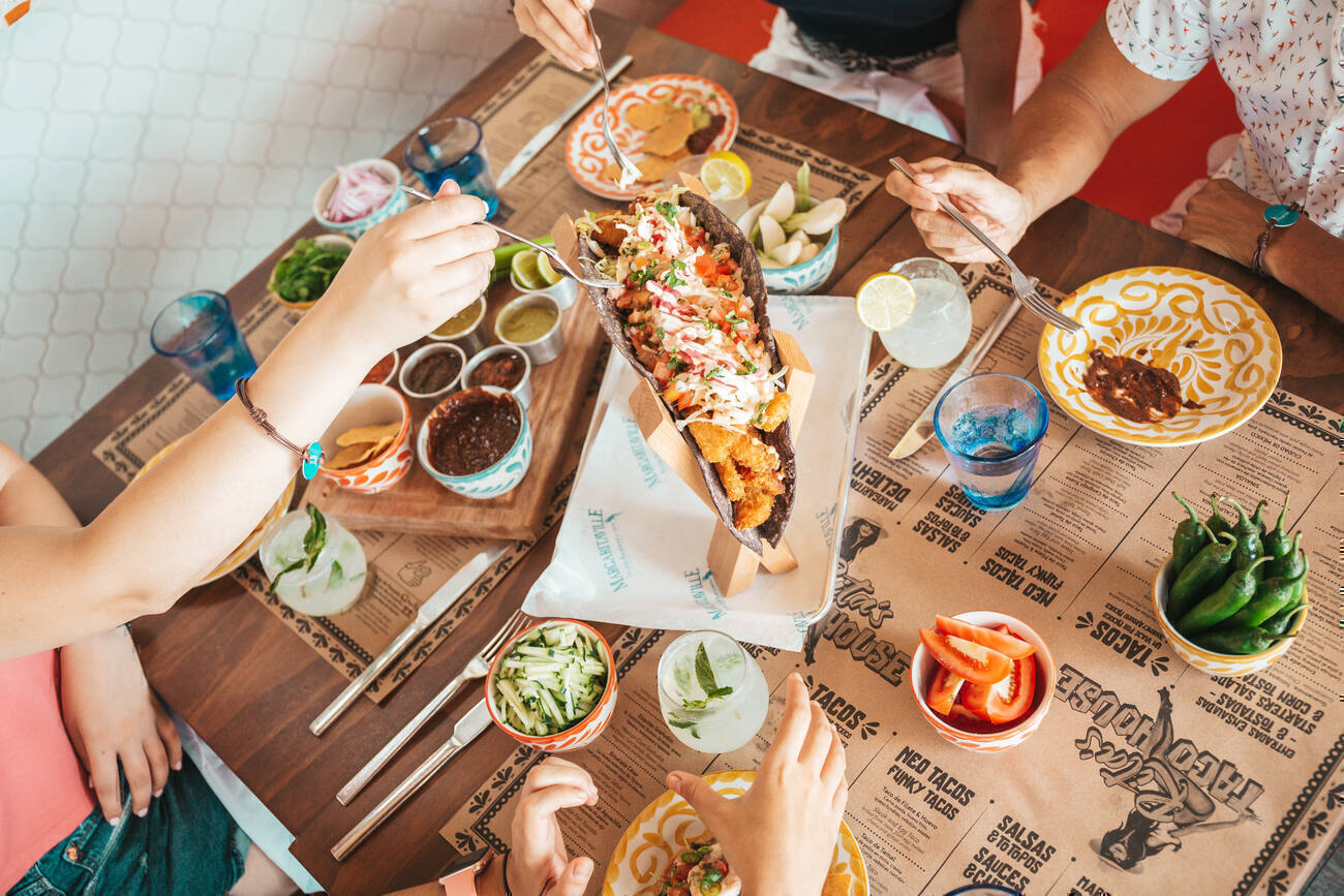 Dinner table with tacos and extra ingredients 