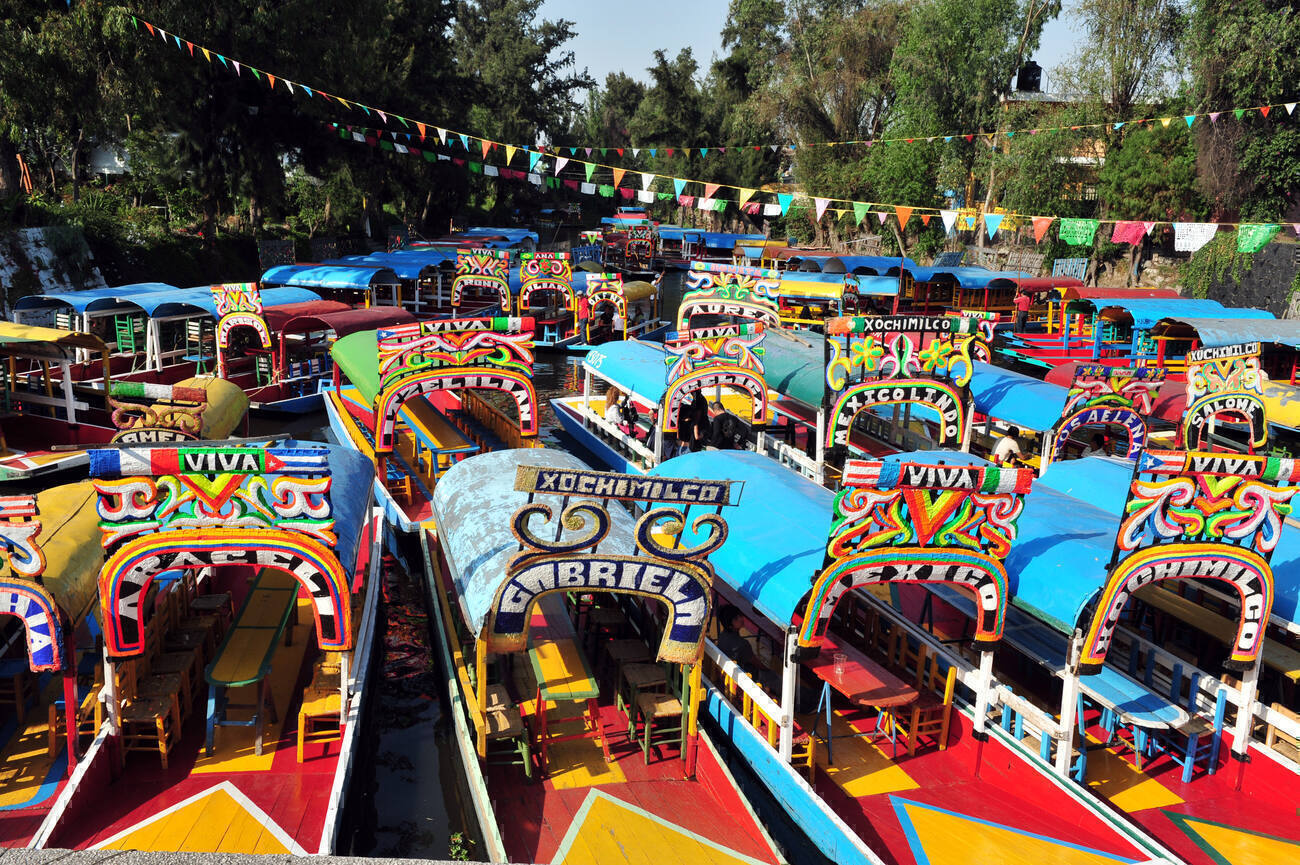 Brightly painted trajinera boats in a canal