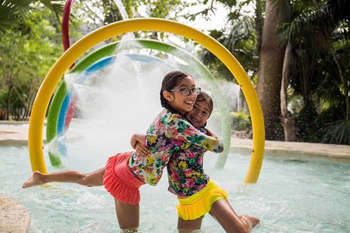 Two girls hugging in a waterpark pool