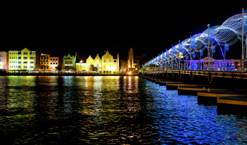 City lit up by the water at night