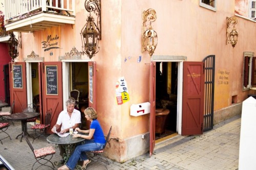 Two people sitting outside a cafe
