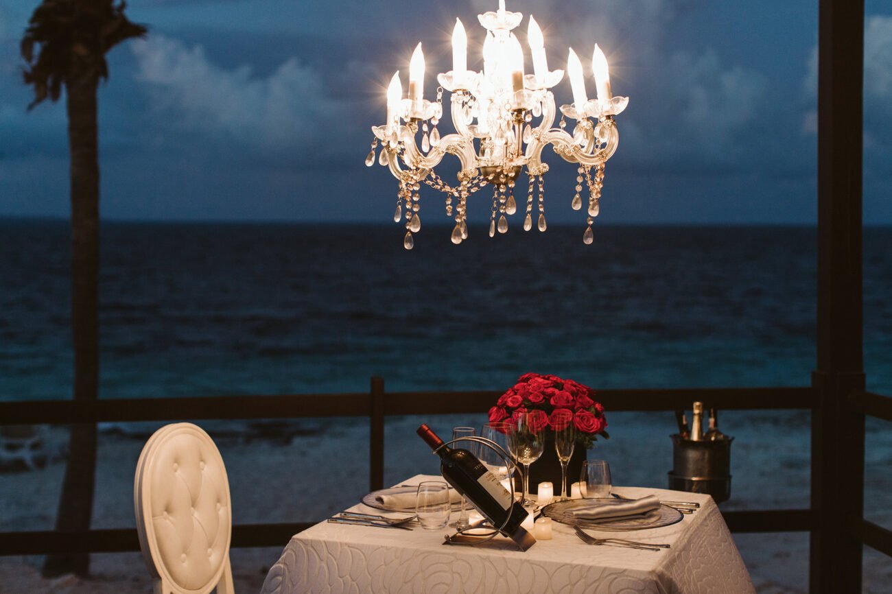 Candlelit dinner table by the ocean