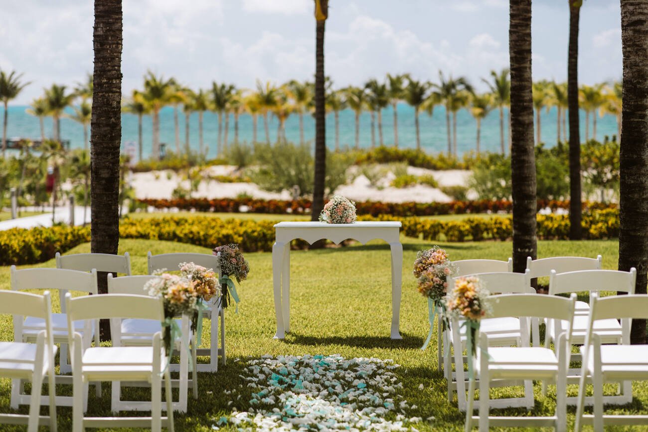 Wedding ceremony set up with flower petals down the aisle