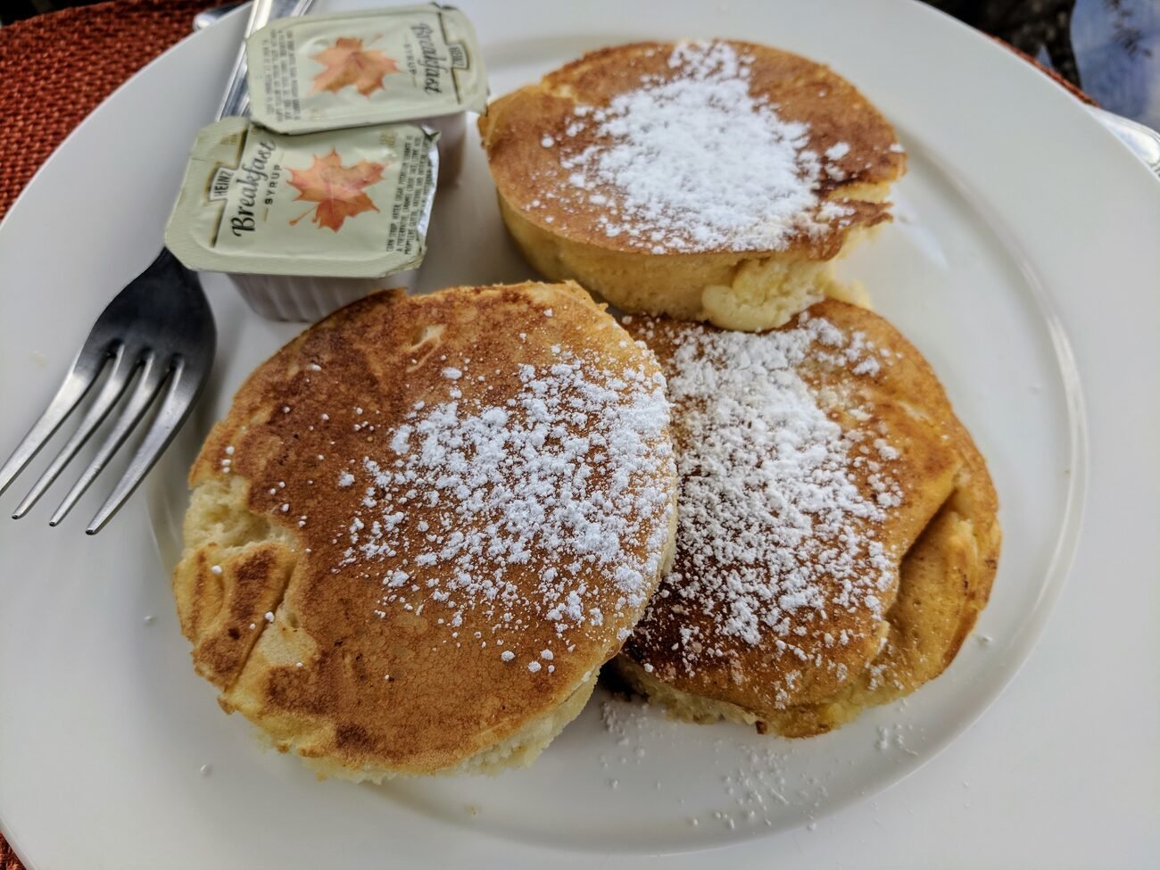 Pancakes with powdered sugar and maple syrup