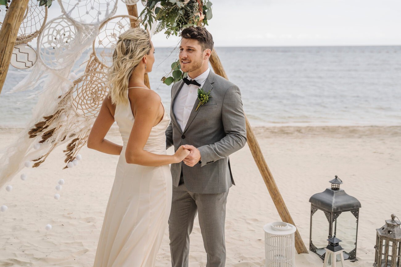 Bride and groom at the alter decorated with dreamcatchers