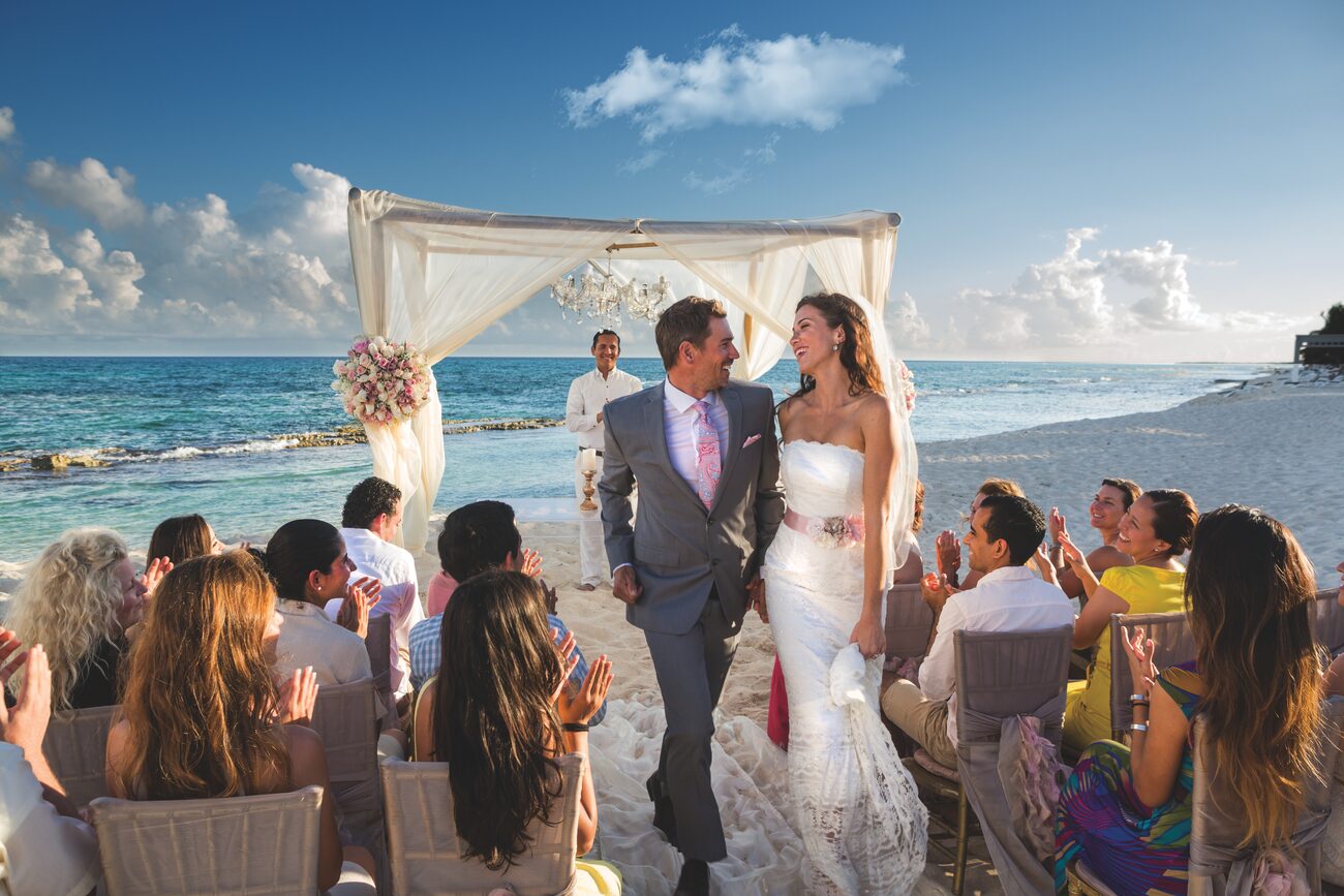 Bride and groom walking down the aisle at their beach wedding