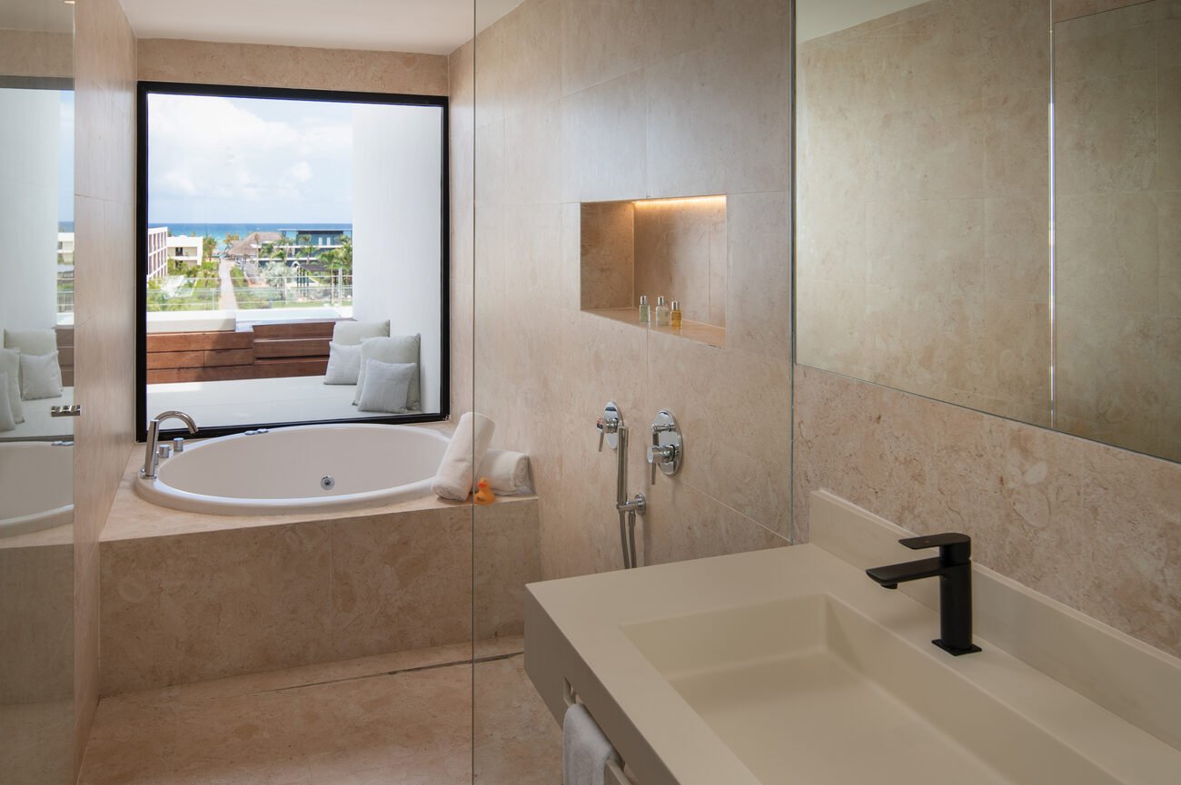 Hotel bathtub with view of the resort and ocean 