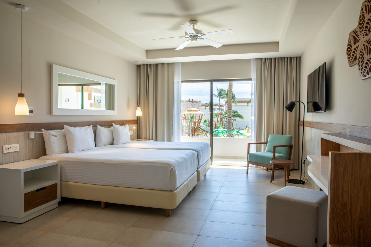 Hotel room with double beds looking out onto a waterpark