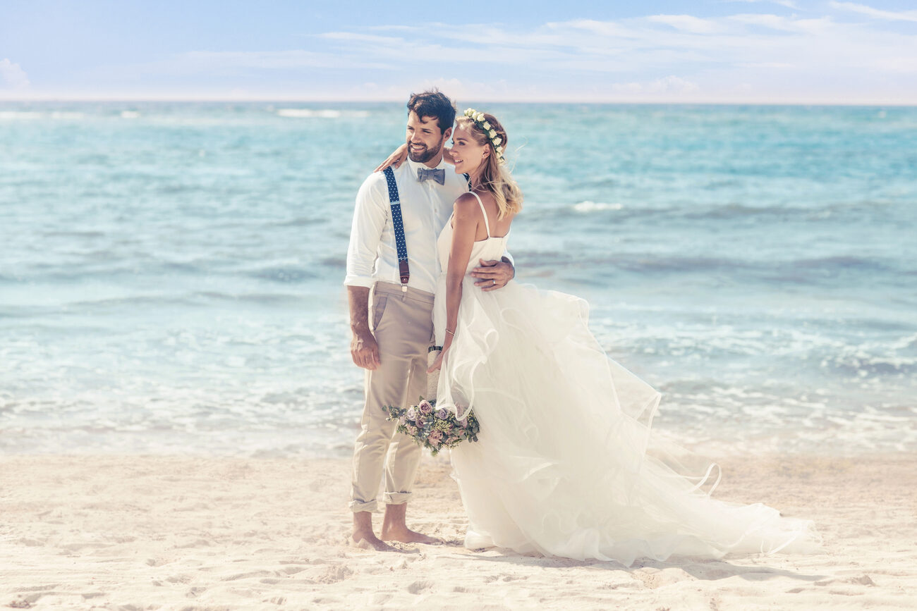 Bride and groom posing on the beach