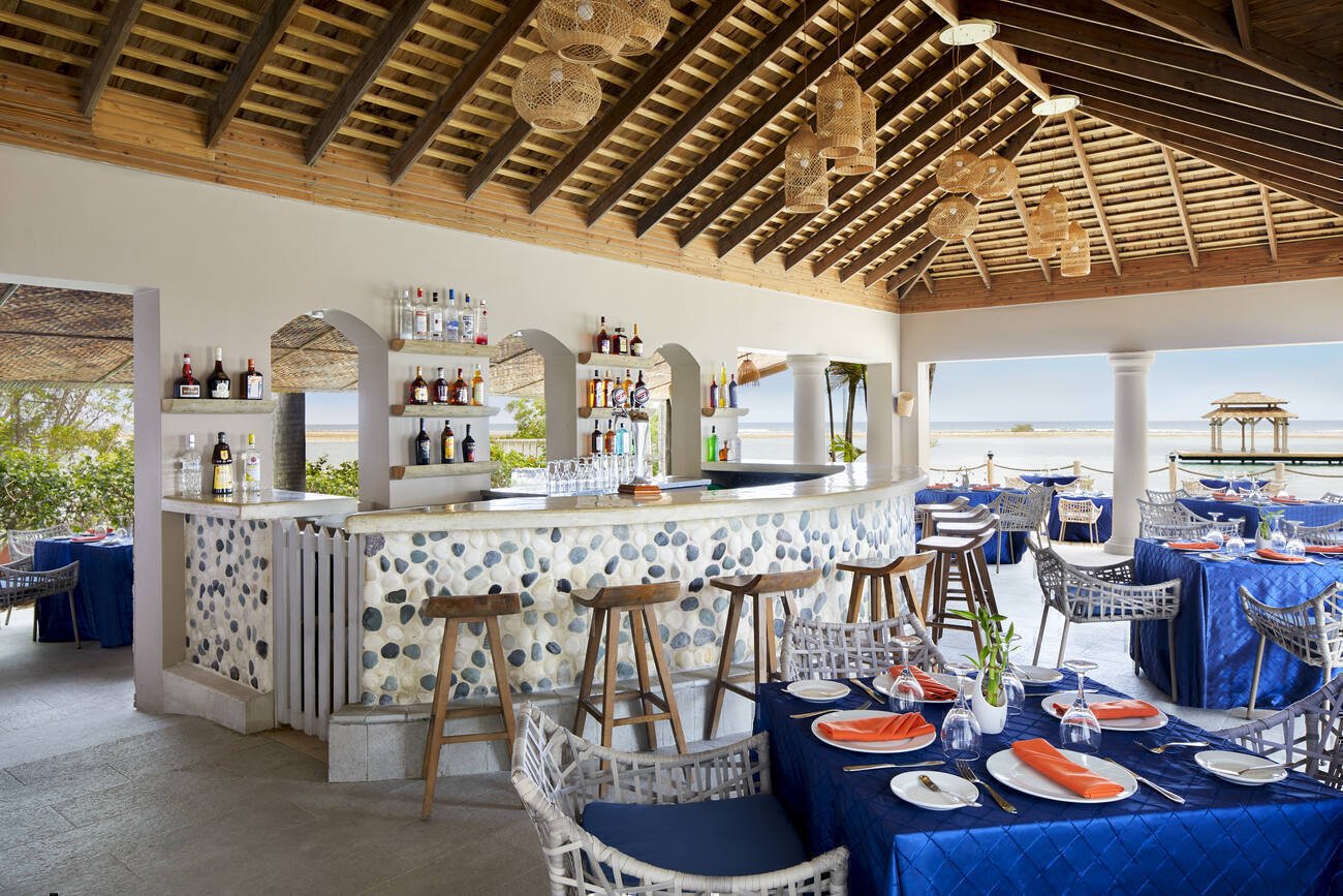 Dining room with a bar on the water