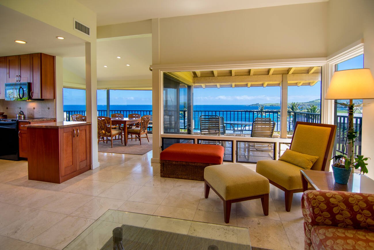 Living and dining area with balcony seating and view of the ocean