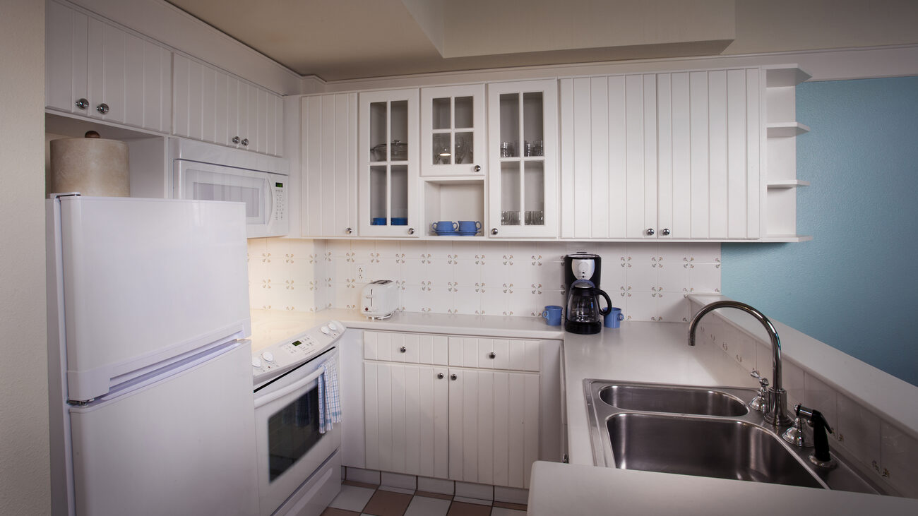 Kitchen with fridge, oven, microwave, and sink