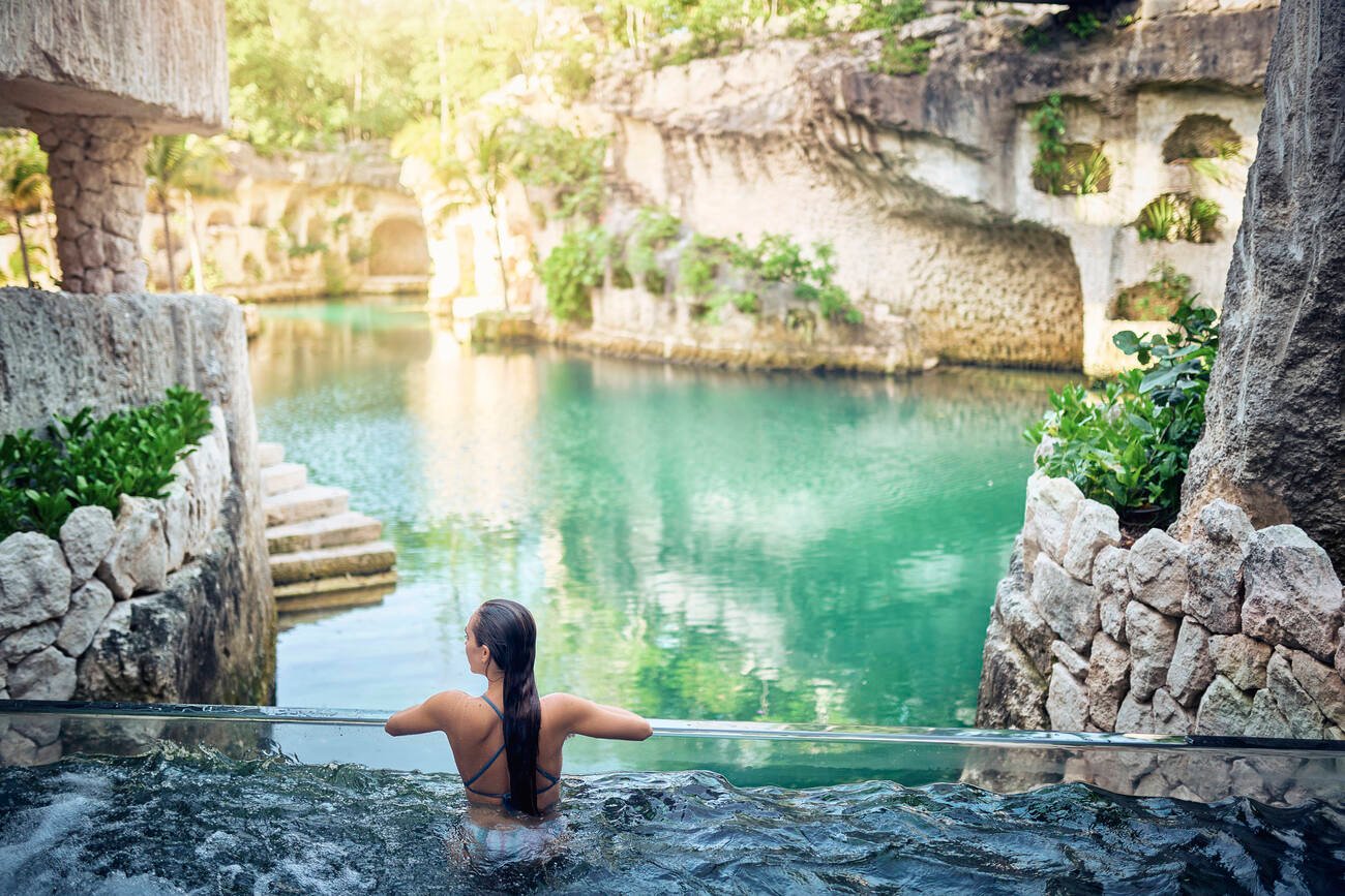 Woman in a pool overlooking the water