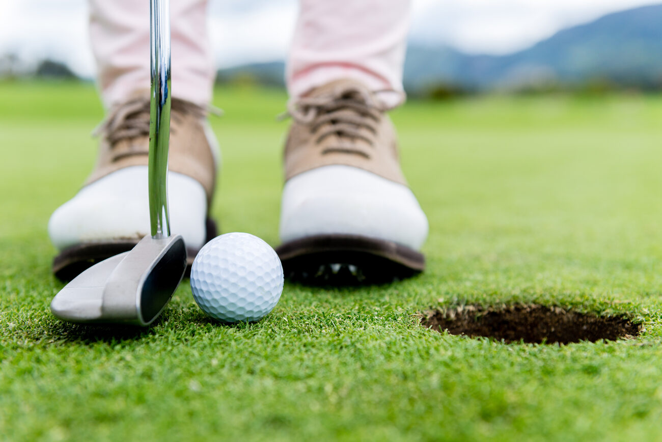 Close up of a golf ball being hit by a golf club