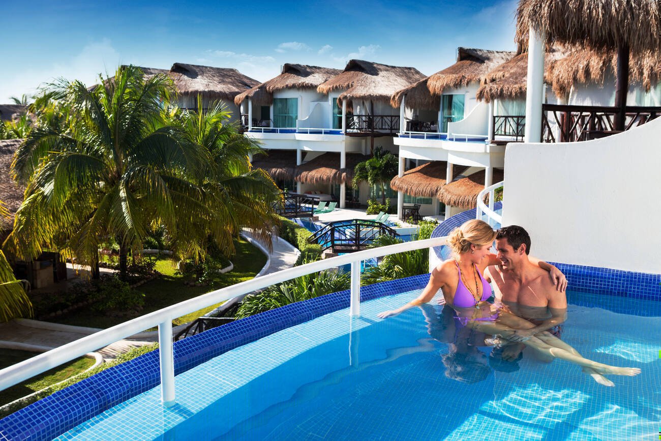 Couple sitting in a pool on their balcony