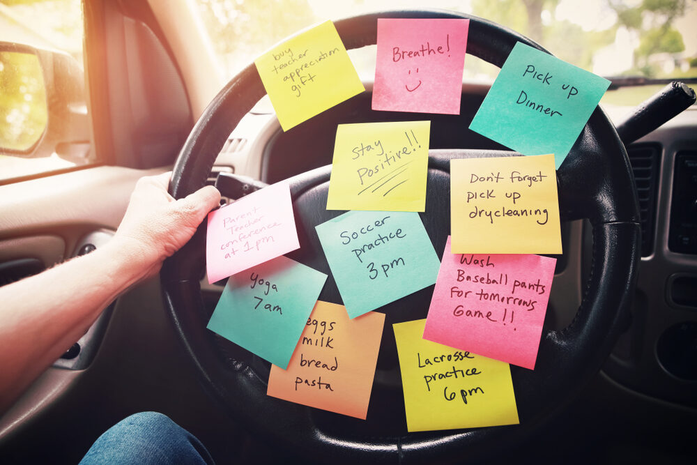 reminder sticky notes on a steering wheel of a car