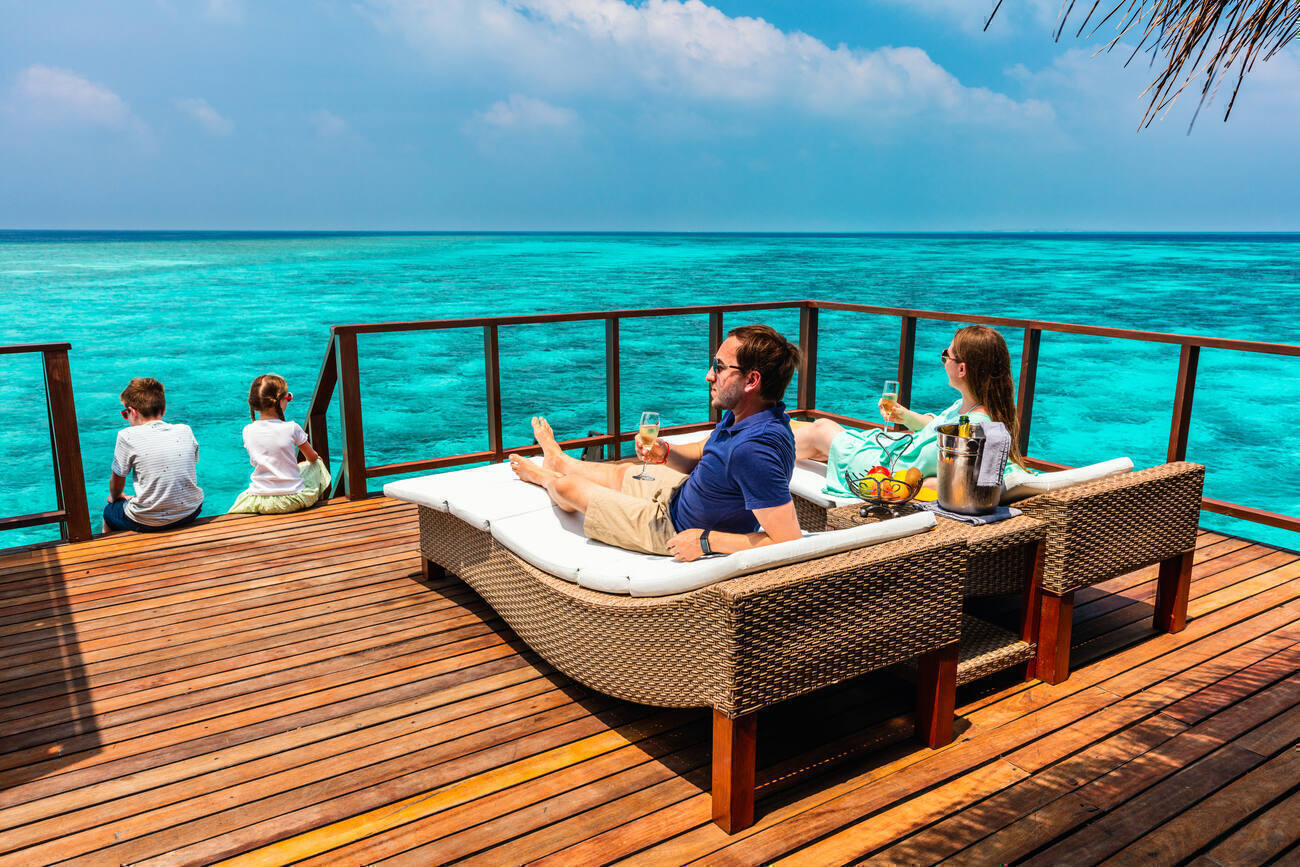 Family sitting on an over the ocean deck 